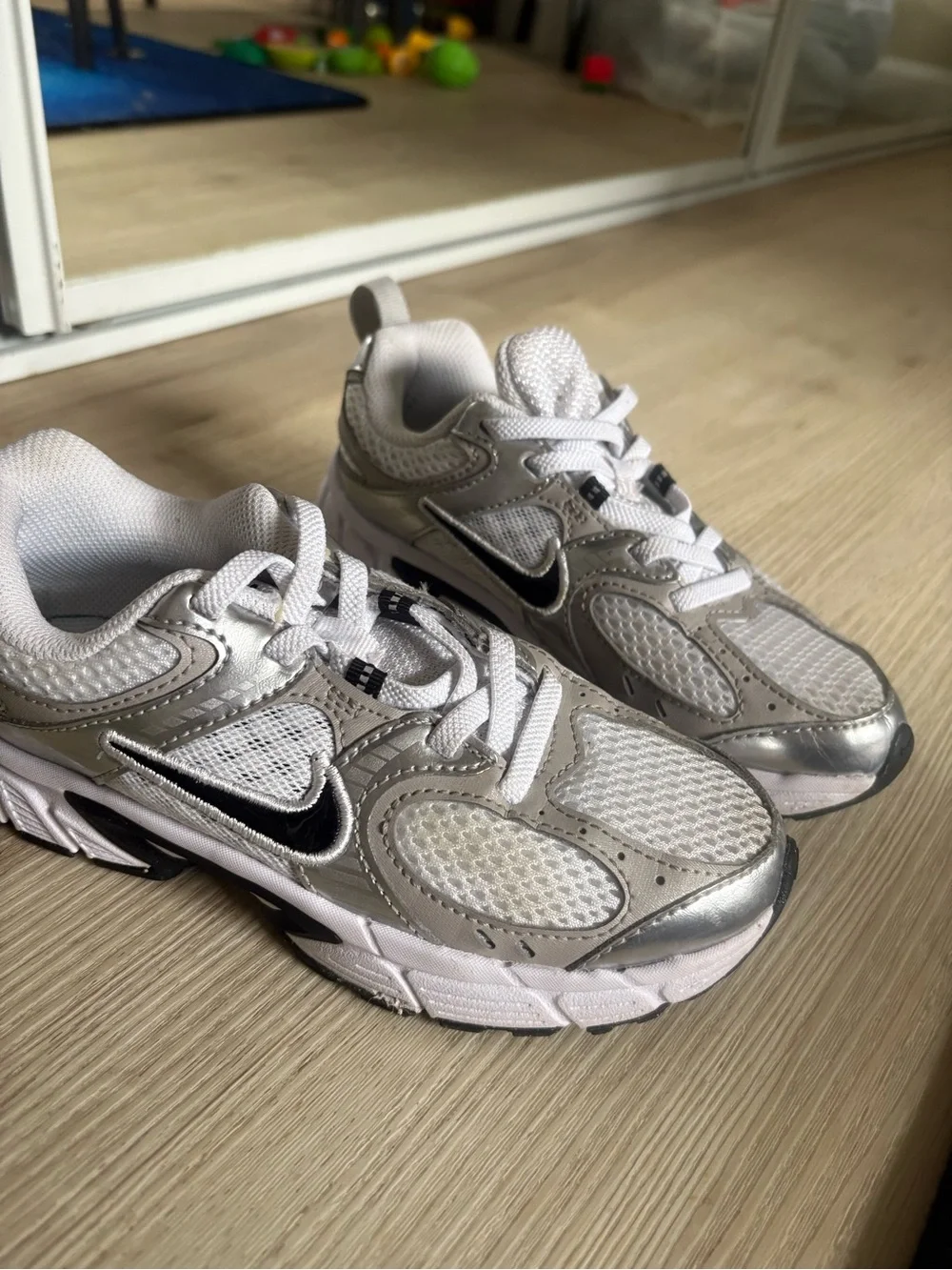 Nike Kids Silver and White Running Sneakers with Black Swoosh